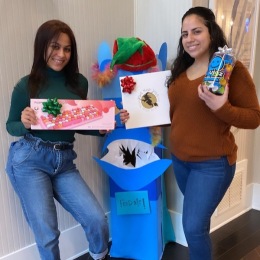women smiling and holding gifts