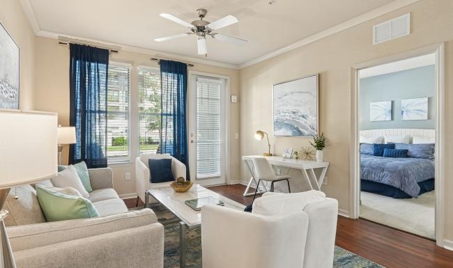 a living room with a couch, tables and chairs