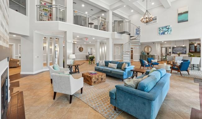 a clubroom with couches, tables and chairs