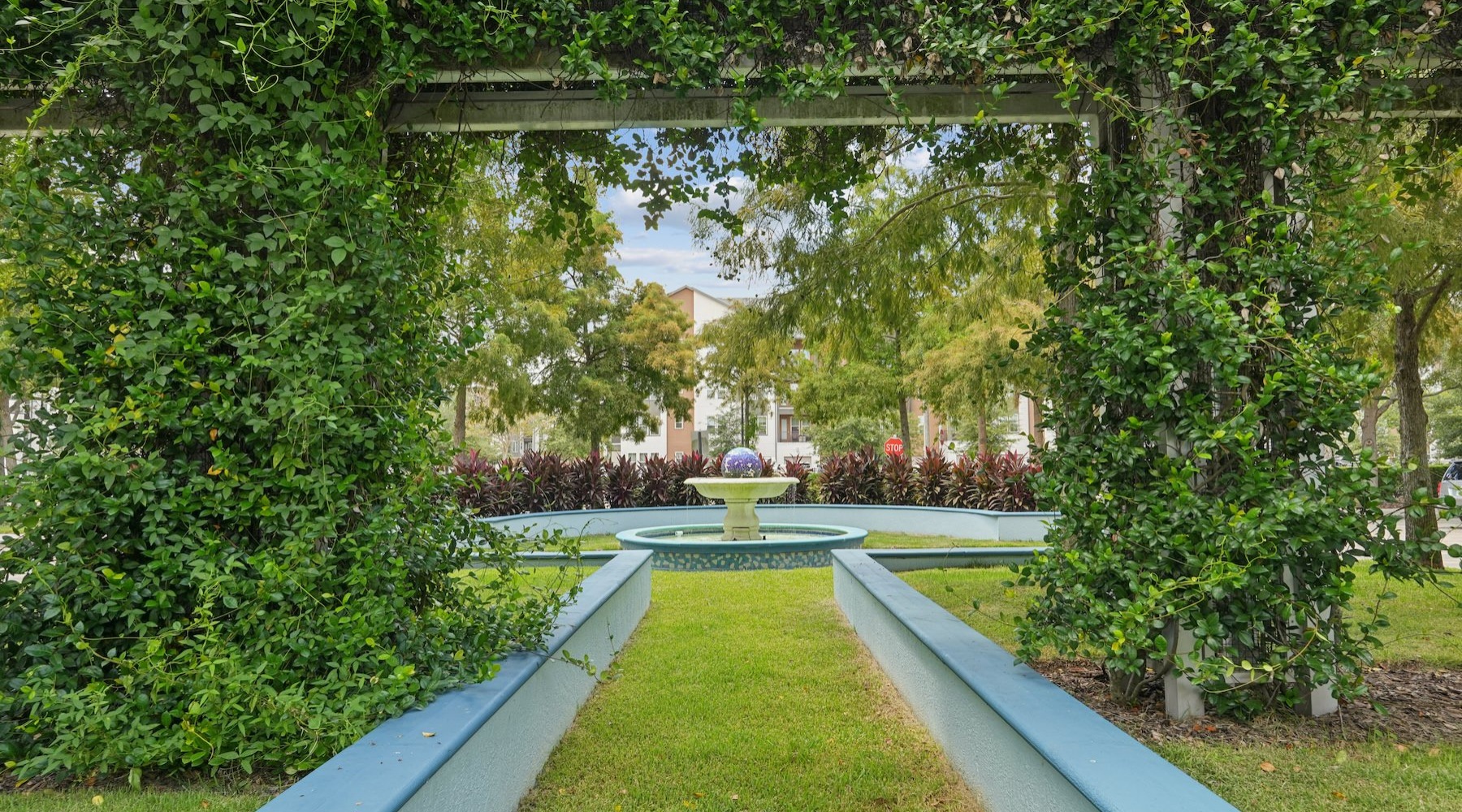 a garden with a water fountain